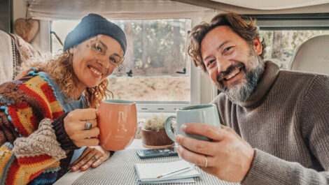 Couple raising a toast with their coffee mugs.