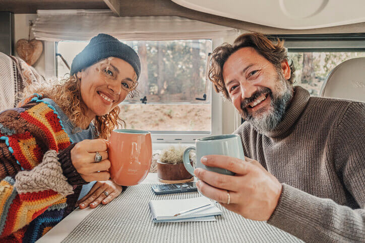 Couple raising a toast with their coffee mugs.