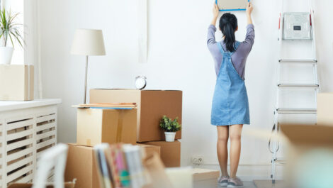 Woman setting up college dorm