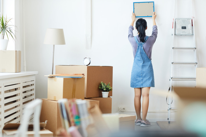 Woman setting up college dorm