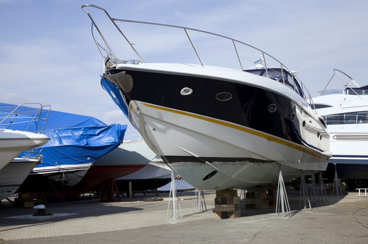 A speed boat parked in a parking lot