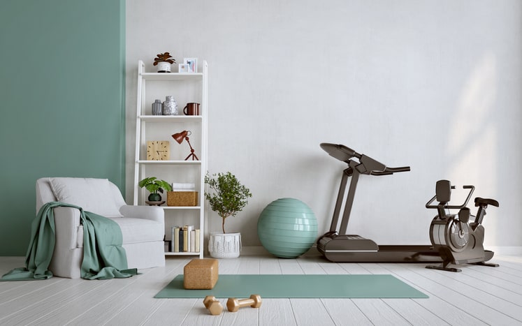 Home gym with treadmill, exercise ball, bike, and weights.