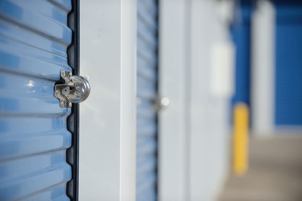 Locked storage unit door in indoor storage facility.