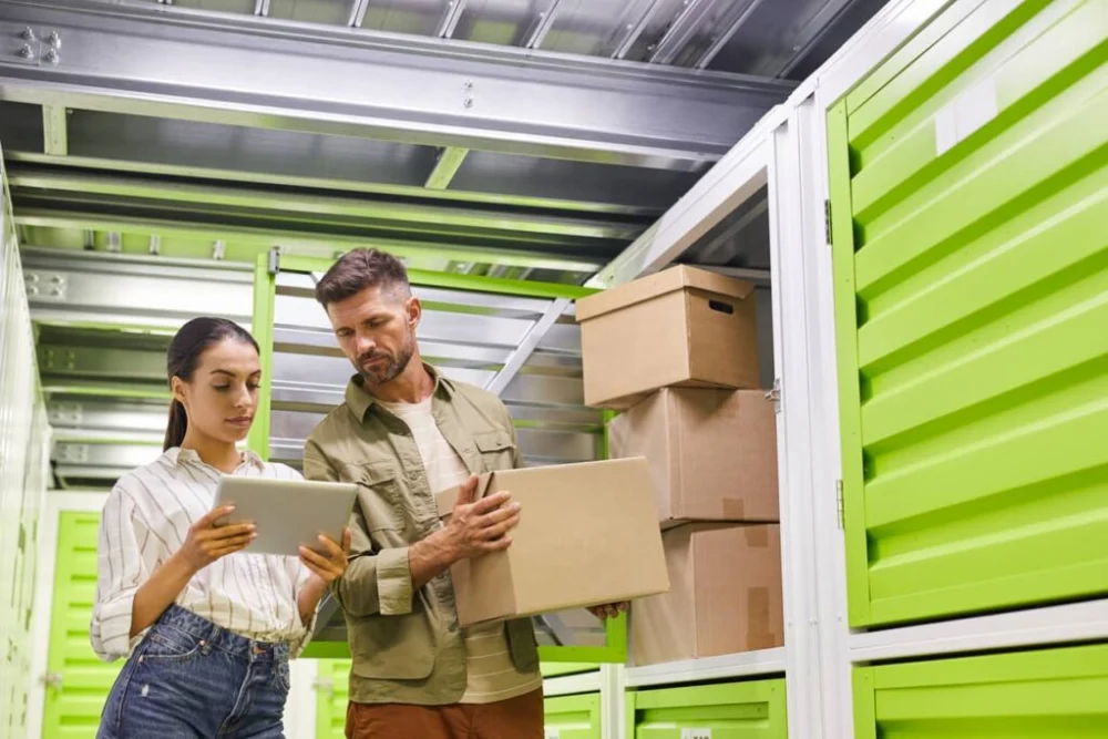 A couple discusses their plans while moving into their storage unit.