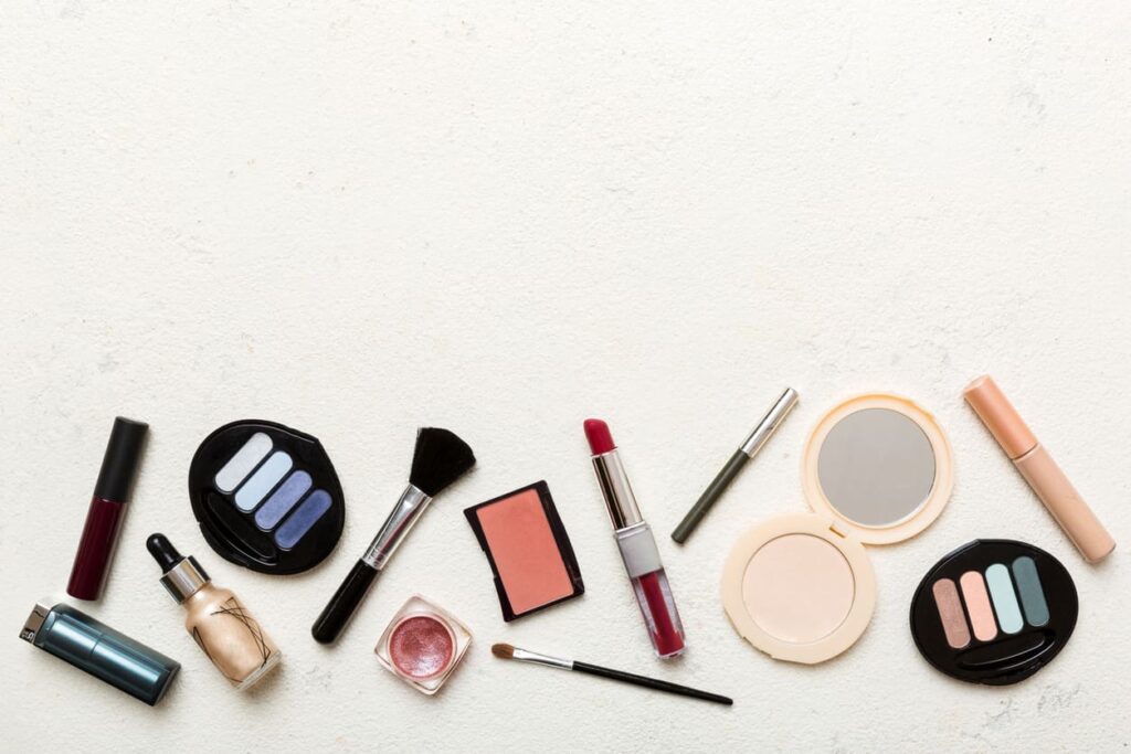 A collection of makeup products displayed in front of a white background.