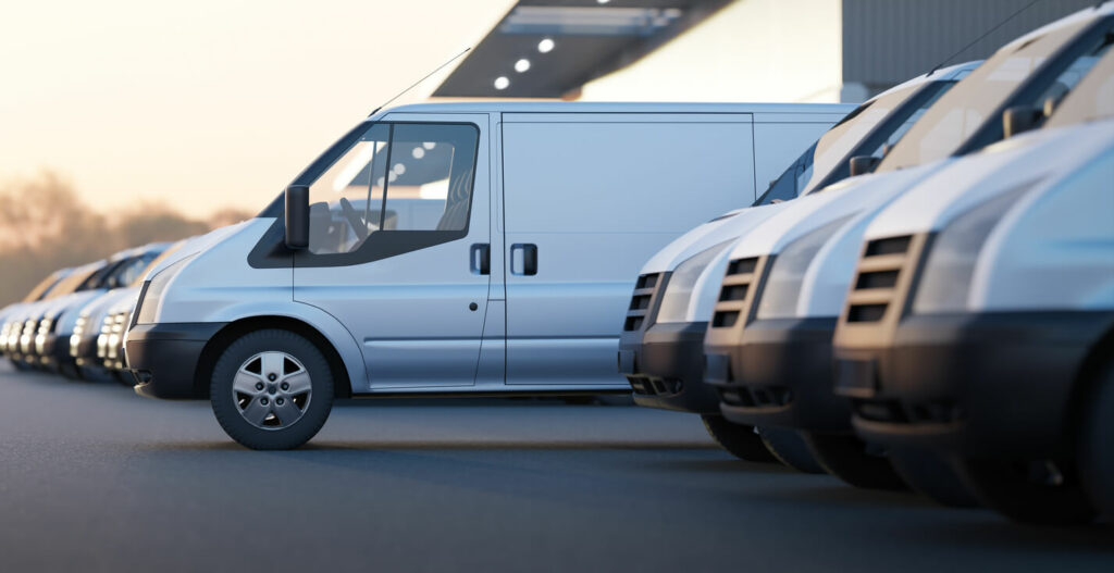 Business vans parked in a secure storage lot.